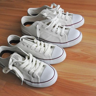 A pair of clean sports shoes and a bottle